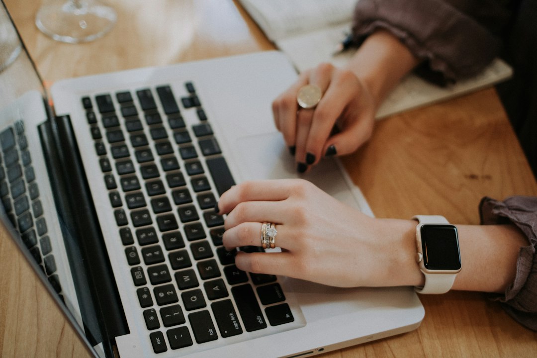 Small business owner planning work with a notebook and laptop